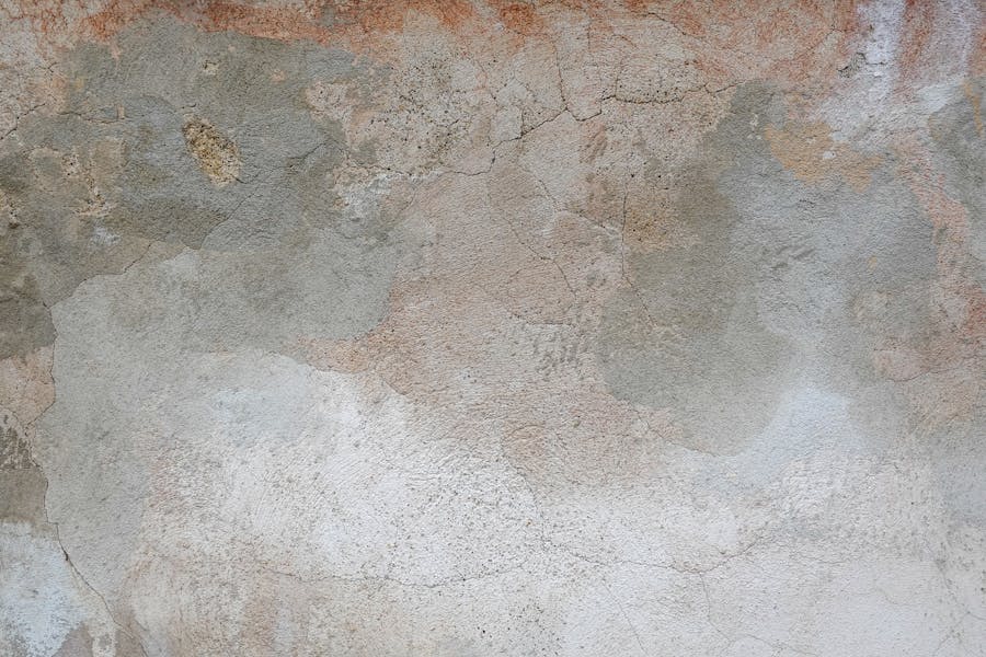 Close-up of a wall surface with cracked old plaster